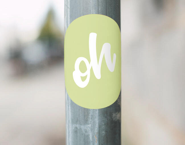 Sticker on a metal post, with "Oh" written on it